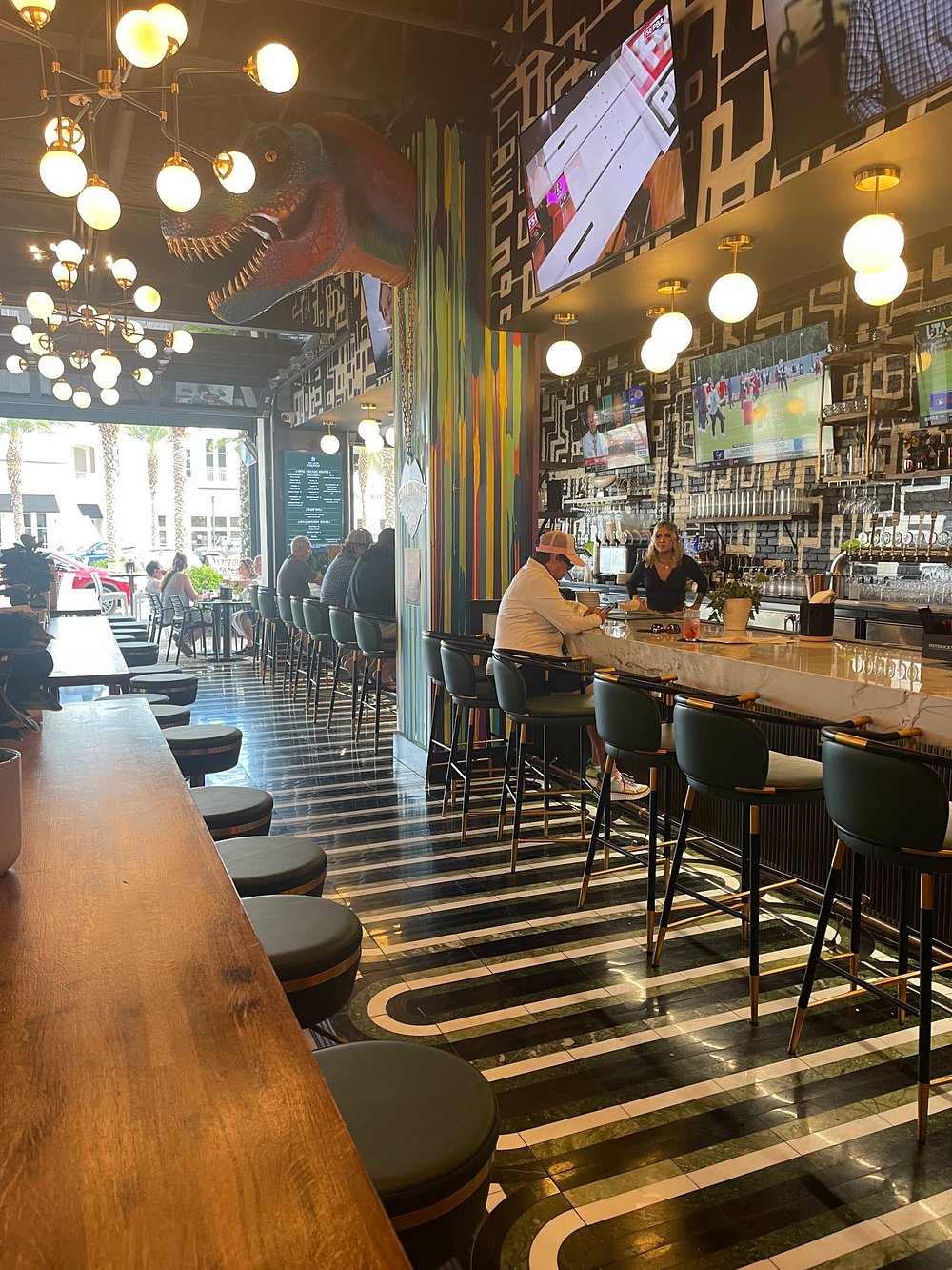 Idyll Hounds Proper interior with signature dinosaur mural